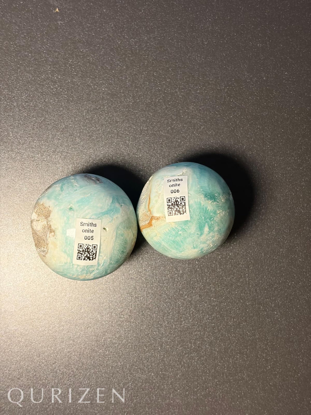 Two Smithsonite spheres with QR codes on a dark gray background, featuring the brand 'Qurizen'.