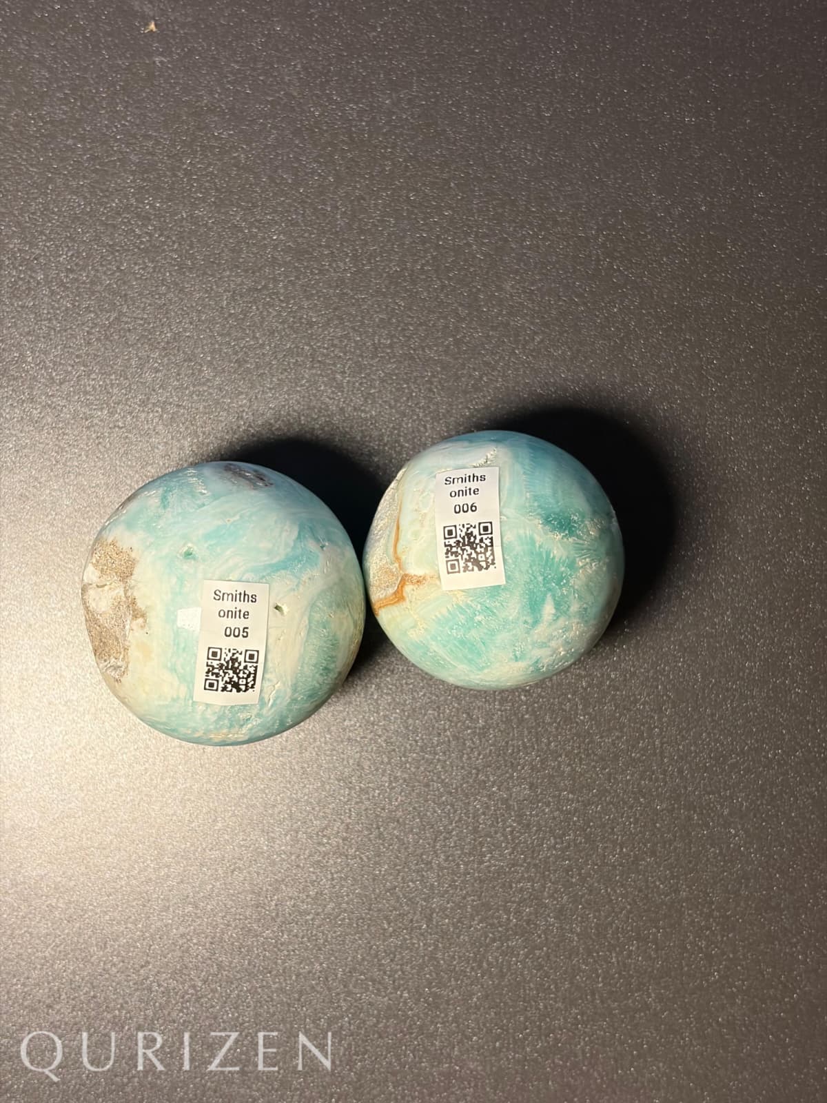 Two Smithsonite spheres with QR codes on a dark gray background, featuring the brand 'Qurizen'.